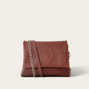 Cartera bandolera VITTORIA PETIT de cuero natural, textura lunares chocolate (café oscuro), vista frontal con cadena