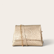 Cartera bandolera VITTORIA PETIT de cuero natural, textura lunares dorado, vista frontal con cadena